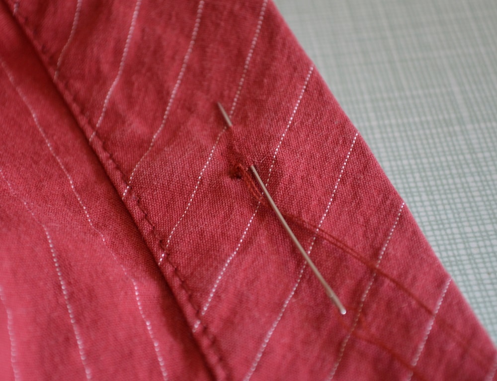 Pass needle between wrong and front fabrics