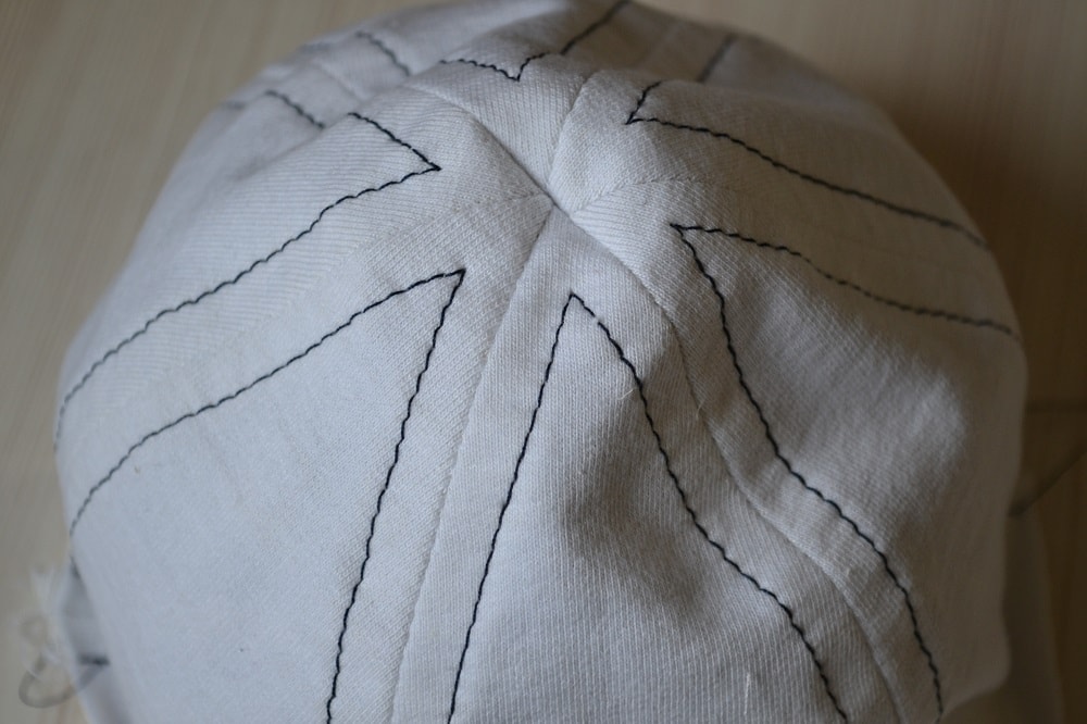 Decorative stitches on face side of hat