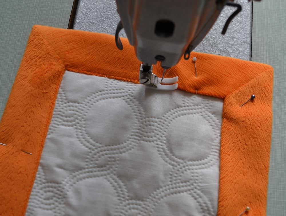 Last step of sewing blanket with mitered corners