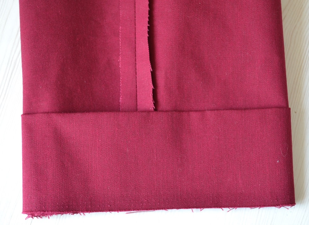 Add the cuffs to the bottom edge of pants leg