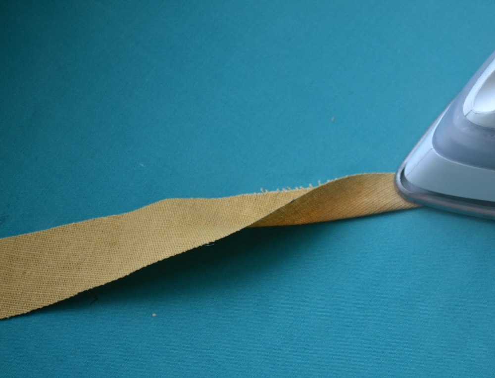 Fold the strip in half and press